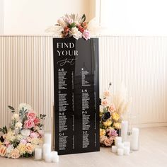 a table plan with flowers and candles on the floor in front of a sign that says find your seat