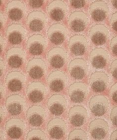 an upholstered fabric with circles and dots in pink, beige and brown colors