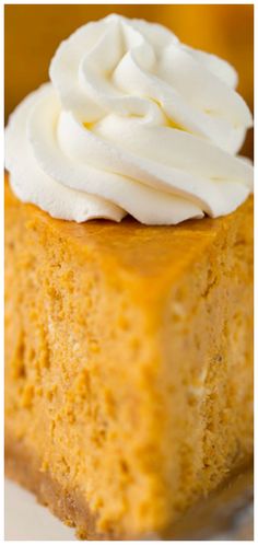 a piece of pumpkin cheesecake with whipped cream on top is shown in this image