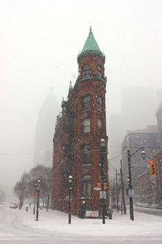 a red brick building covered in snow on a city street