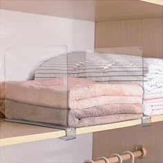 several folded towels are sitting on shelves in a closet