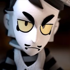 a close up of a toy with yellow eyes and black stripes on it's face