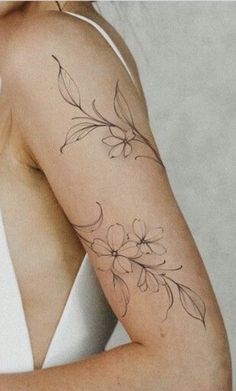 a woman with a flower tattoo on her arm