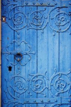 an old blue door with ornate designs on it