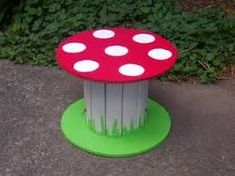 a mushroom shaped table sitting on top of a sidewalk