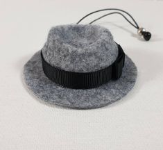 a gray hat with a black ribbon around the brim