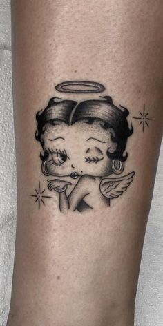 a woman's leg with an angel tattoo on it