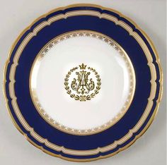 a blue and white plate with gold trim