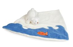 a polar bear laying on top of a blue and white blanket with a goldfish