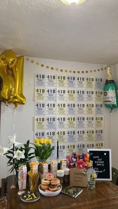 a table topped with lots of food next to balloons and confetti on top of it