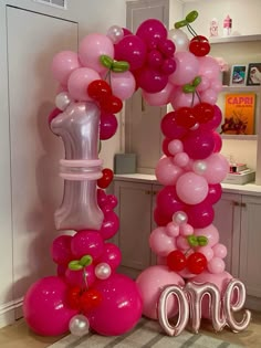 balloons are arranged in the shape of an o - letter, with cherries on them