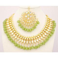 DESCRIPTION This is a set of Kundan Choker Necklace Earrings Tikka With Pearls. (Indian Necklace, Bollywood Necklace, Asian Necklace, Traditional Necklace, Ethnic Necklace, Designer Necklace, Fashion Necklace, Wedding Necklace, Bridal Necklace) ITEM DESCRIPTION Metal = Gold Plated Occasion = Wedding ,Party Wear, Bridal Color = Light Green and Yellow Size = Necklace Length = 7 Inches Long, Earring Size = 3.5 Inches Long, tikka - 6 Inches Long Free Shipping Green Jewelry Sets With Dangling Beads For Gift, Green Beads For Party And Festivals, Green Kundan Beaded Necklace For Parties, Green Kundan Necklace With Dangling Beads For Festivals, Traditional Green Beads For Party, Beaded Jewelry Sets For Party Festivals, Green Jewelry Sets For Celebration, Beaded Jewelry Sets For Party And Festivals, Green Beaded Necklace For Festivals And Parties