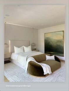 a large bed sitting in the middle of a bedroom next to a painting on the wall