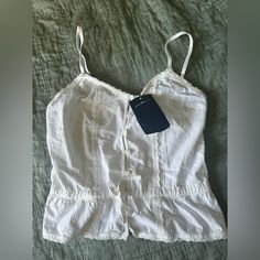 Brandy Melville White Tank Top New With Tags Never Worn White Cotton Tank Top For Daywear, Summer White Camisole For Daywear, White Cotton Camisole For Day Out, White Camisole Tops For Vacation, White Cotton Summer Camisole, White Fitted Summer Camisole, White Casual Camisole Top, White Cotton Camisole For Vacation, Casual White Camisole For Day Out