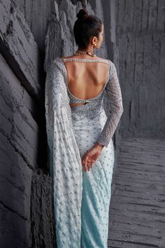 Ice blue ombre saree with silver sequin embroidered floral motifs. Paired with blouse.
Components:2
Pattern:Embroidery
Type of Work:Sequin, floral
Neckline:Deep V neck
Sleeve Length:Full sleeves
Fabric:Butterfly net, satin georgette
Color:Blue
Other Details:
Scallop bordered saree
Embroidered blouse
Back tassel detailing
Back cut-out
Closure: Blouse: Hook and eye
Occasion:Destination Wedding - Aza Fashions Silver Pre-draped Saree With Mirror Work For Diwali, Silver Blouse Piece With Mirror Work For Reception, Silver Semi-stitched Pre-draped Saree For Designer Wear, Silver Pre-draped Saree With Resham Embroidery For Reception, Silver Pre-draped Saree With Mirror Work, Fitted Silver Pre-draped Saree For Designer Wear, Festive Silver Pre-draped Saree With Resham Embroidery, Silver Pre-draped Saree With Unstitched Blouse For Designer Wear, Silver Blouse Piece With Mirror Work In Traditional Drape