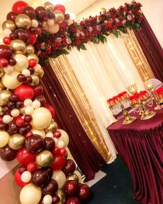 the balloon arch is decorated with red, white and gold balloons for an elegant party