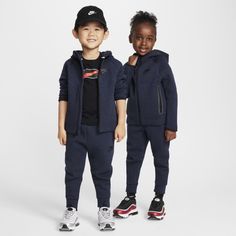 Made of bonded jersey knit fabric, this 2-piece set is inspired by the classic warmup suit. The hoodie has a full-zip closure that makes layering easy, and the matching tapered pants have ribbed cuffs and an elasticized waistband for a comfy fit little athletes can play freely in. Nike Tracksuit For Sports, Sporty Hoodie For Winter Playwear, Sporty Winter Hoodie For Playwear, Casual Hooded Outerwear For Training, Hooded Sportswear Outerwear For Jogging, Nike Hooded Activewear For Jogging, Sporty Hooded Hoodie For Playwear, Navy Winter Sports Tracksuit, Nike Hooded Tracksuit Athleisure