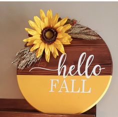 a wooden sign that says hello fall with a sunflower