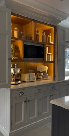 a kitchen with an oven, microwave and cabinets