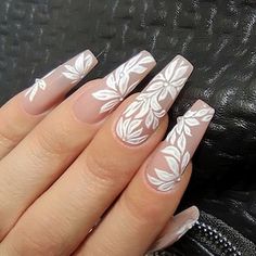 a woman's hand with white flowers on it