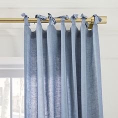 blue curtains hanging on a rod in front of a window