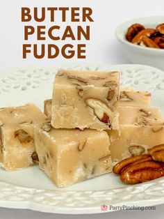 pieces of pecan fudge on a white plate with pecans in the background