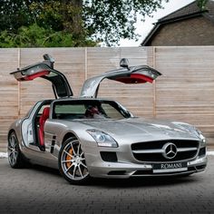 a mercedes sls roadster with its doors open and it's door opened