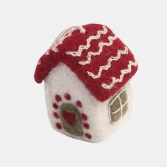 a small white and red house ornament