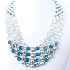 This graceful handmade nautical necklace has the twinkle and soothing palette of an oceanside escape. Its gentle color ombre fades from silver and teal, to clear and aquamarine, and then to milky whit Nautical Necklace, Crystals Swarovski, Ocean Breeze, Precious Jewelry, Beaded Jewelry Diy, Rock Crystal, Jewelry Patterns, Jewelry Projects