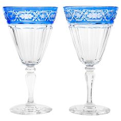 two blue glass goblets sitting next to each other