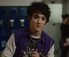 a young man standing in front of lockers