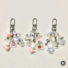 three key chains with charms attached to them