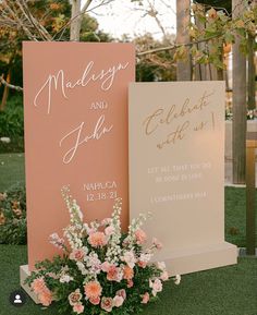 two wedding signs with flowers in front of them