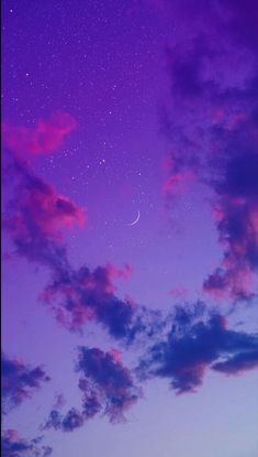 the night sky is purple and blue with stars in it, as well as some clouds