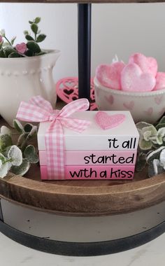 a present box sitting on top of a table next to flowers and potted plants