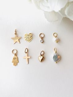 *Ready-to-Ship Jewelry - Ready-to-Ship jewelry will ship within 1-2 business days. You can add a charm to another piece from our shop. Item Details: This is a listing for ONE(1) Charm. ( Including a jumping 7mm ) Ster charm - 12mm, 14k gold filled. Puffed Heart drop- 8mm 14K gold filled. Potato pearl - Natural White Freshwater Pearl, about 5-6 mm, 14k gold filled.  Reese Pearl - Natural Coin Pearl, about 10mm, 14k gold filled.  Cross - 14k gold filled, 16mmx10mm. Hamsa - gold plated, 12mmx10mm. Earrings Charms, Permanent Jewelry, Gold Hamsa, Hoop Charms, Silver Wings, Puffed Heart, Coin Pearls, Travel Jewelry Case, Minimal Jewelry