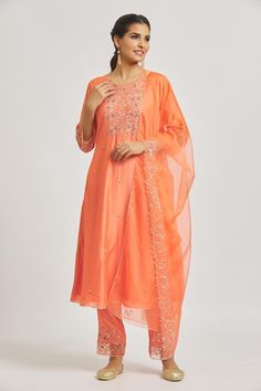 Orange A-line kurta with floral vine and mirror work embroidery. Comes with embroidered hem pant and dupatta.
Components: 3
Pattern: Embroidered
Type Of Work: Floral Vine
Neckline: Notched
Sleeve Type: Three Quarter
Fabric: Organza, Muslin, Chanderi
Color: Orange
Other Details: 
Attached lining
Back elasticated pant waistband
Length:
Kurta: 48
Pant: 37
Approx. product weight: 1 kg
Occasion: Puja - Aza Fashions Mirror Work Embroidery, Embroidered Hem, Kurta Set For Women, A Line Kurta, How To Hem Pants, Floral Vine, Mirror Work, Kurta Set, Set For Women