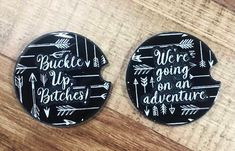 two black and white magnets with arrows on them that say we're going on an adventure