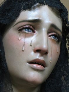 a woman with tears on her face and head