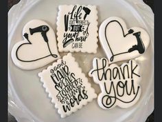 four decorated cookies on a plate with thank you written on the front and back pieces