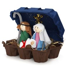 a nativity scene with three people in a manger