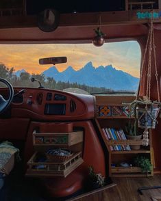 an interior view of a vehicle with mountains in the background and shelves on the side