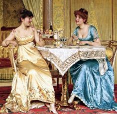 two women sitting at a table having tea