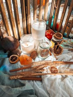 an assortment of candles and fruit on a table