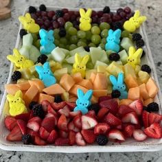 a platter filled with different types of fruits and veggies in the shape of bunnies