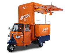 an orange and blue food truck parked on top of a white background with the word aprrol above it