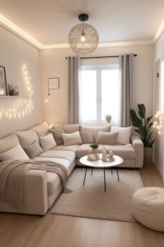 a living room filled with lots of furniture and lights on the wall above it's windows