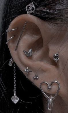 a woman with ear piercings and chains on her ears