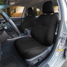 the interior of a car with black seats and steering wheel covers on it's side