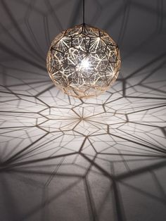 a light that is hanging from the ceiling in a room with white walls and flooring